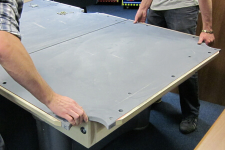 A slate bed being fitted to a pool table.