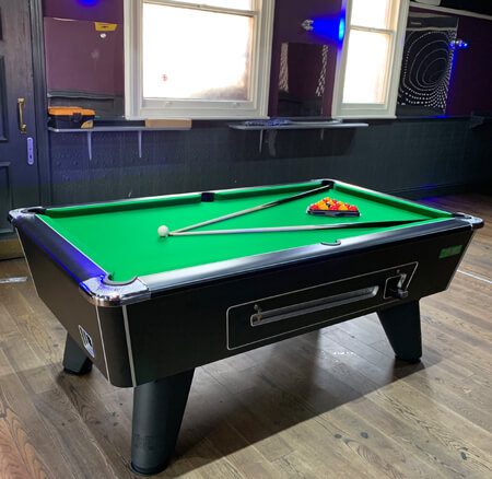 A coin-operated Supreme Winner pool table.